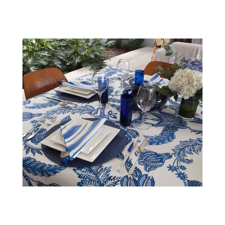 Costa blu 59x122 inch tablecloth, featuring cool blue tones, draped over a dining table.