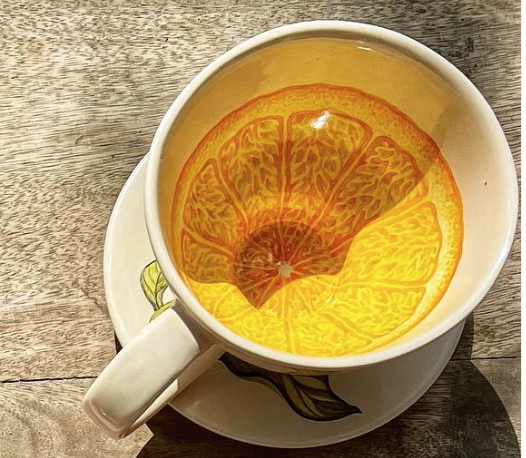 Hand painted botanical tea cup and saucer with an orange botanical illustration. Chic hostess gift.