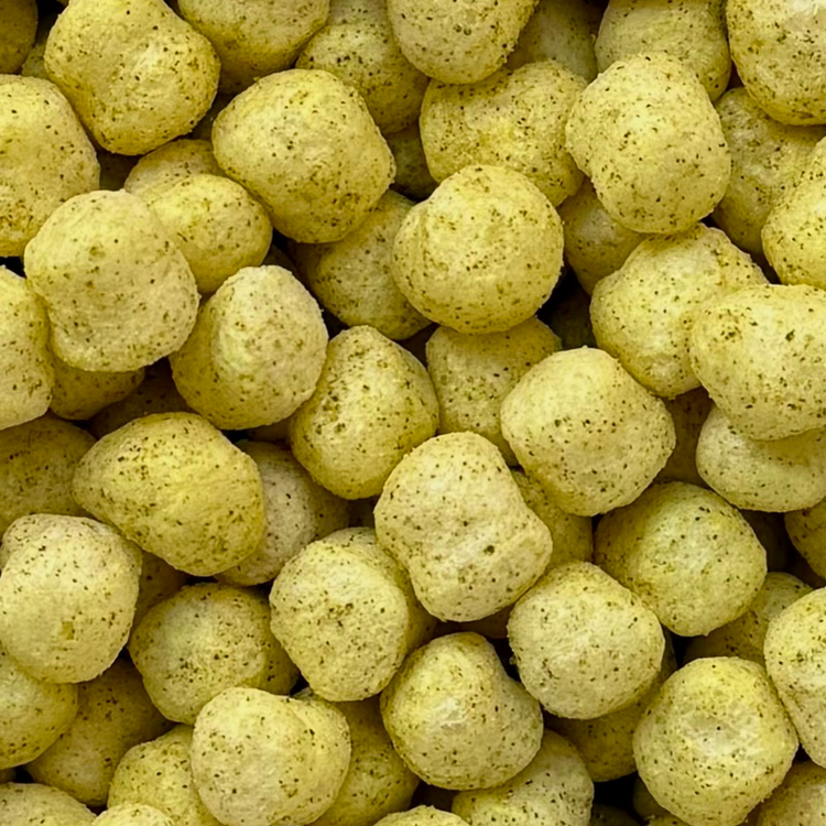 Close-up of yellow cereal sorghum puffs, crunchy, lemon herb flavor, savor snack, gluten-free