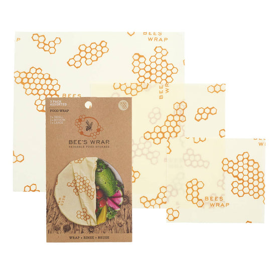 Three assorted sizes of honeycomb bowl covers laid out flat with the packaging that reads 'BEE'S WRAP'.