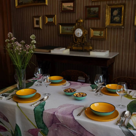 Datura 87x87 inch tablecloth, featuring a bold floral print on a high-quality fabric, displayed on a dining table