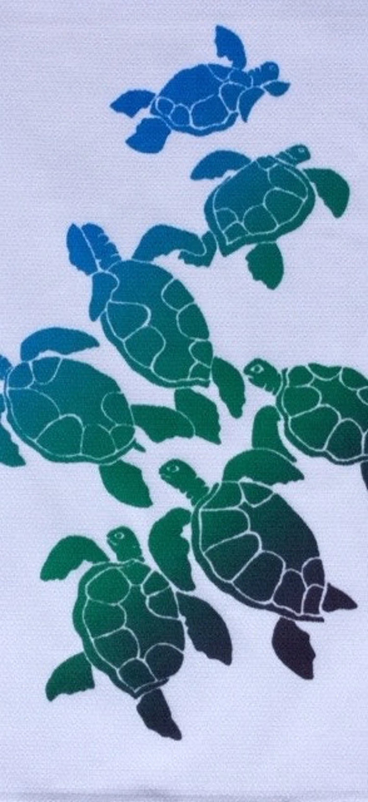 A kitchen towel with a hand-screened geometric turtle design in various shades of green.