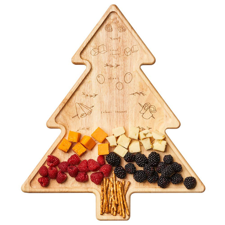 Tree-shaped wooden cutting board with fruits and cheese on a white background