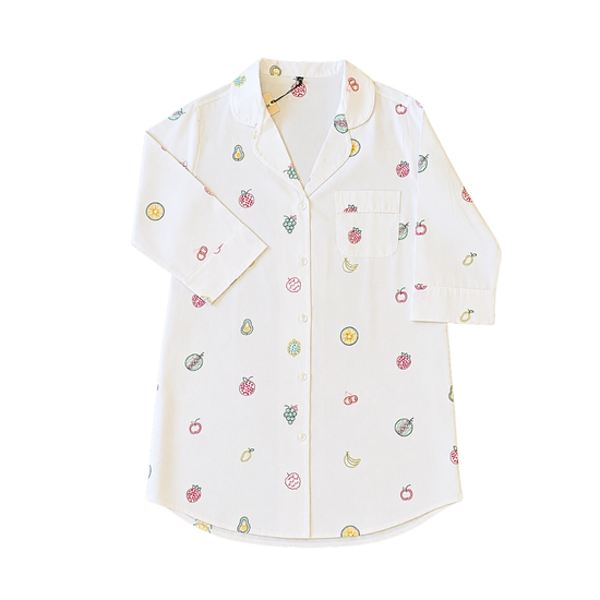 White shirt with colorful fruit patterns on a white background. Size large white cotton long-sleeve pajama top decorated with delicate, vibrant hand-stitched fruit patterns.
