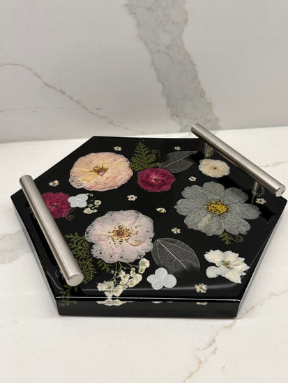 Decorative tray with floral designs on a marble surface