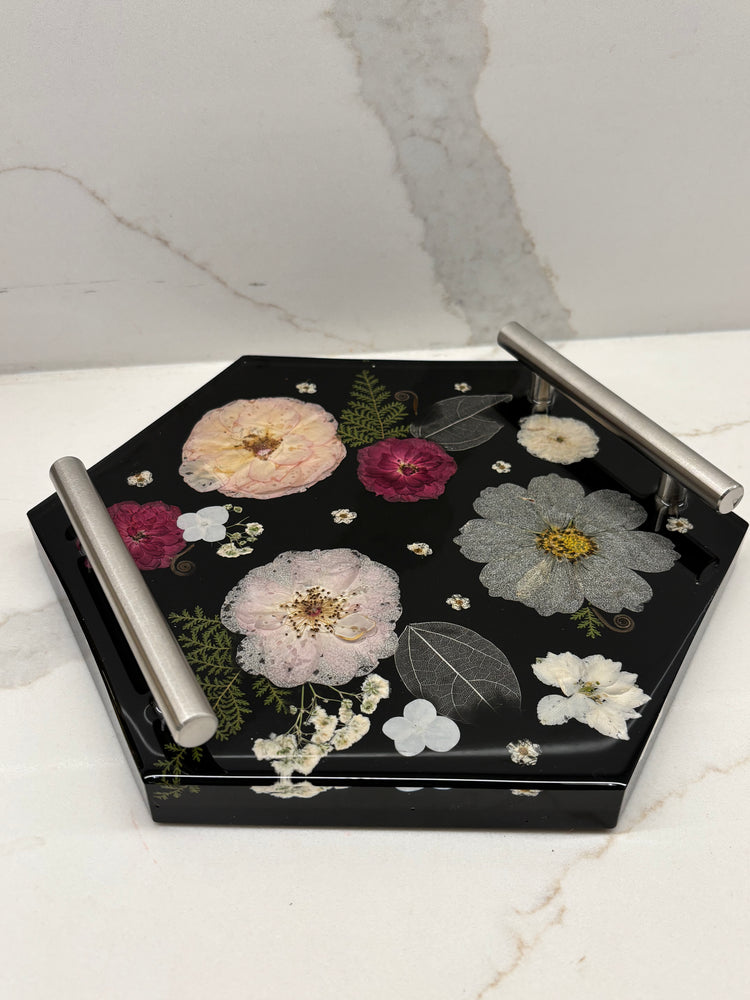 Decorative tray with floral designs on a marble surface