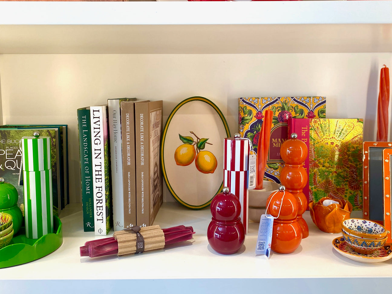 Decorative items including books, a plate with lemons, and colorful kitchen accessories on a shelf.